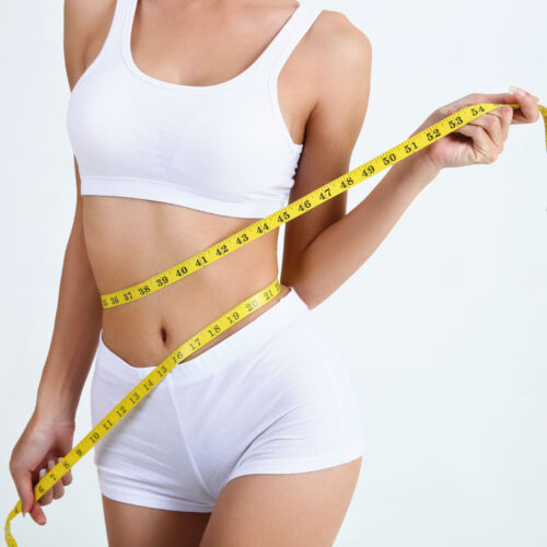 Young woman with measure tape around her body | Aesthetics Beauty Boutique | Miami Florida