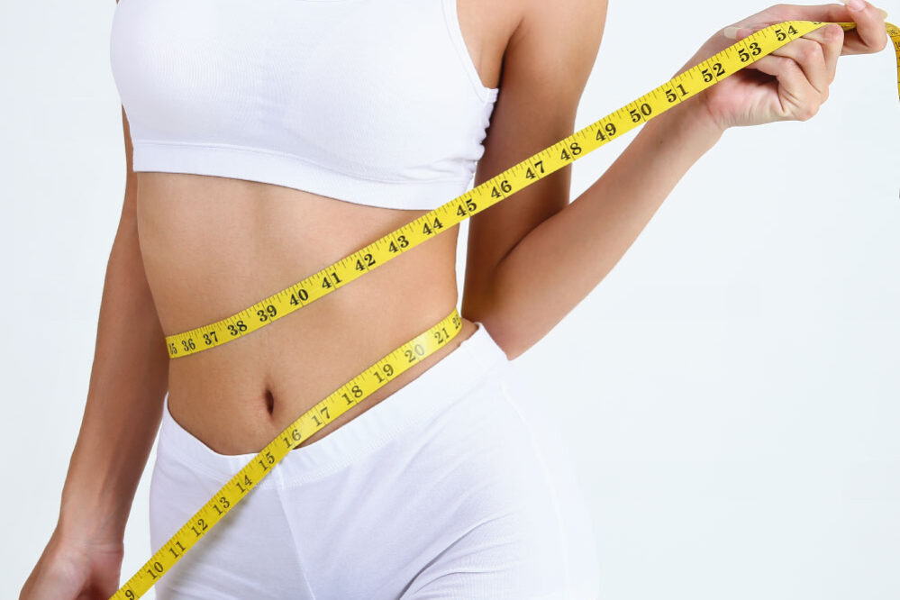 Young woman with measure tape around her body | Aesthetics Beauty Boutique | Miami Florida